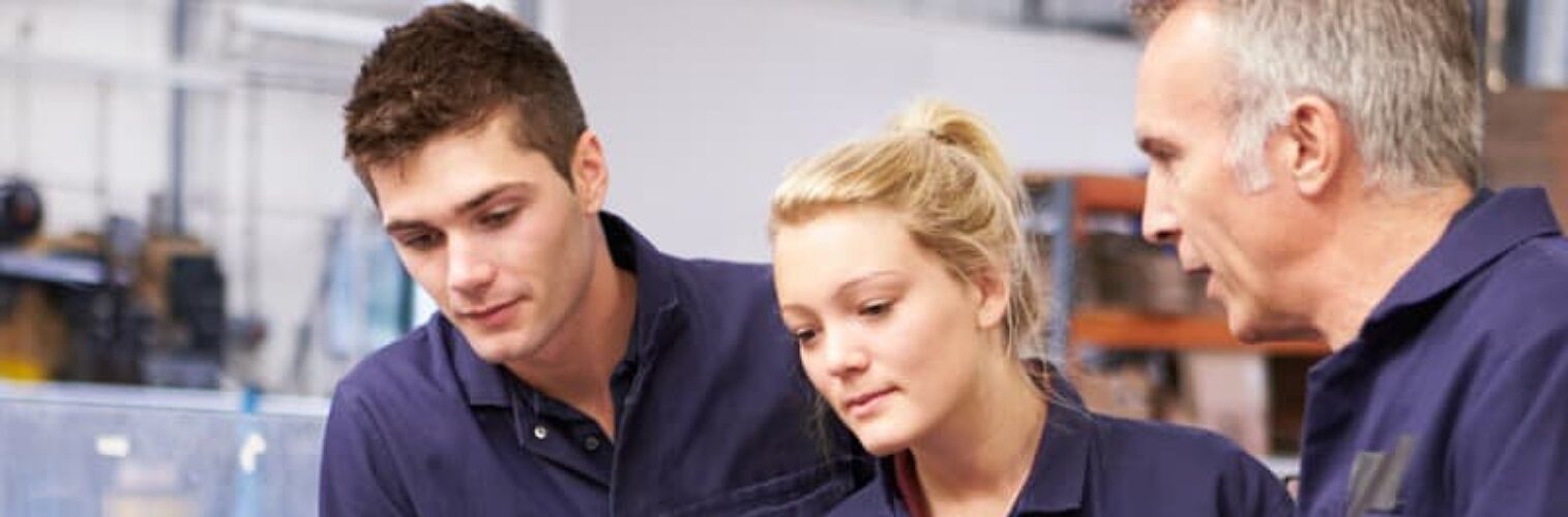 Two young people being taught by an instructor