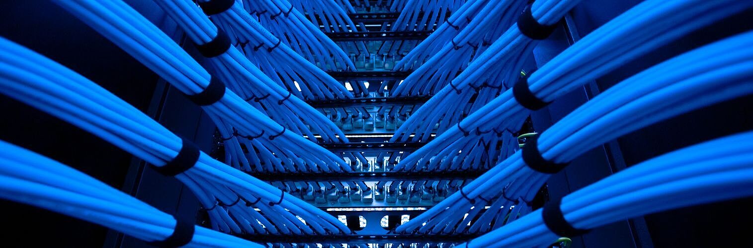 Bright blue cables in a network server.