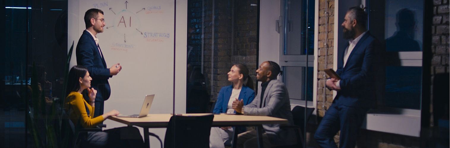 Diverse business team discussing artificial intelligence in a modern office at night.