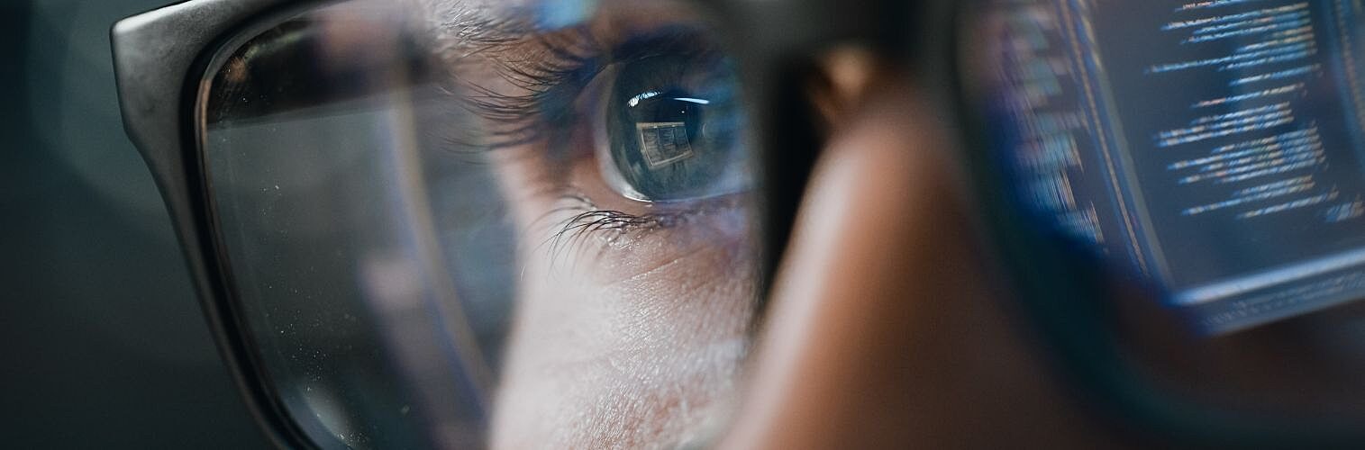 Close-up portrait of a software engineer working on a computer.