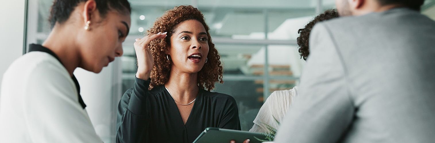 A woman at a meeting with her team.