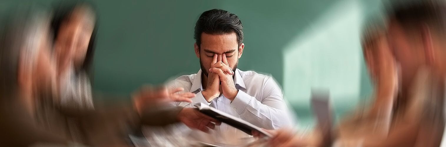 Businessman in a meeting feeling frustrated.
