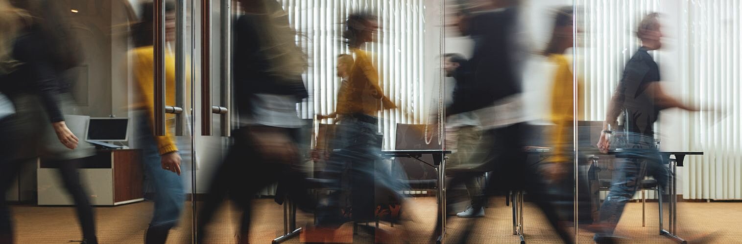 Businesspeople walking in a modern office.