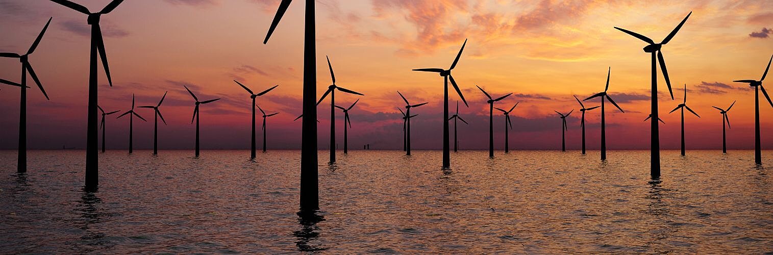 Offshore wind turbines at sunset.