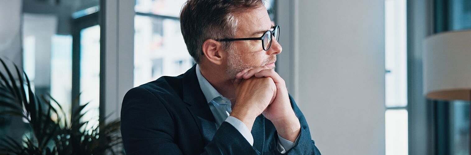 Businessman thinking in his office.