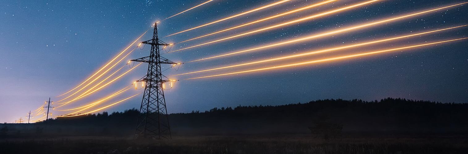 Electricity transmission towers with glowing orange wires.