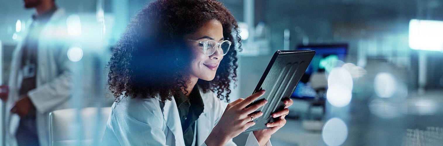 Female doctor consulting a tablet.