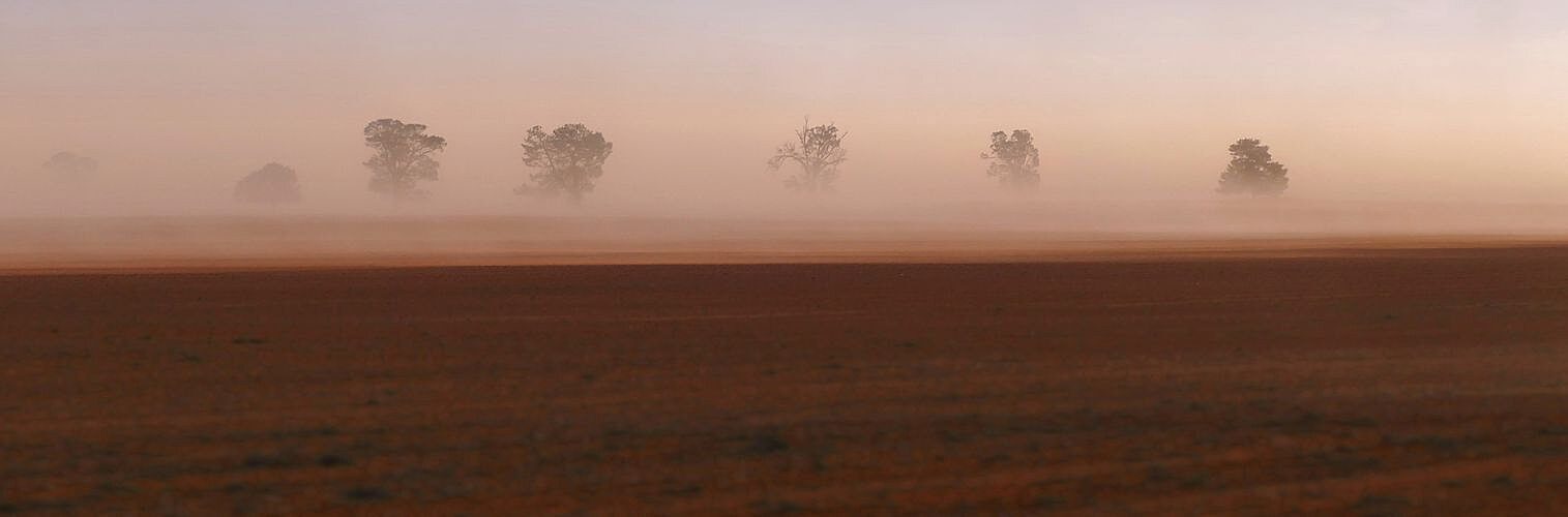 A dust storm in outback Australia on a rural farm.