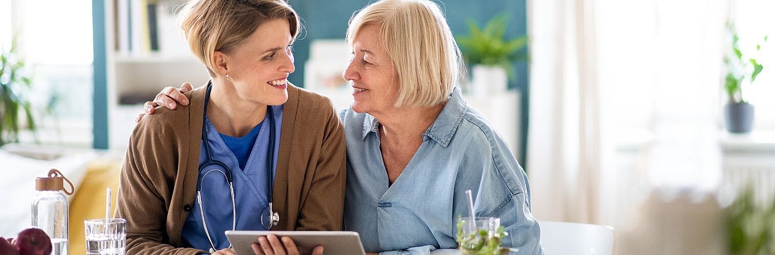 A doctor visiting an elderly patient at home.