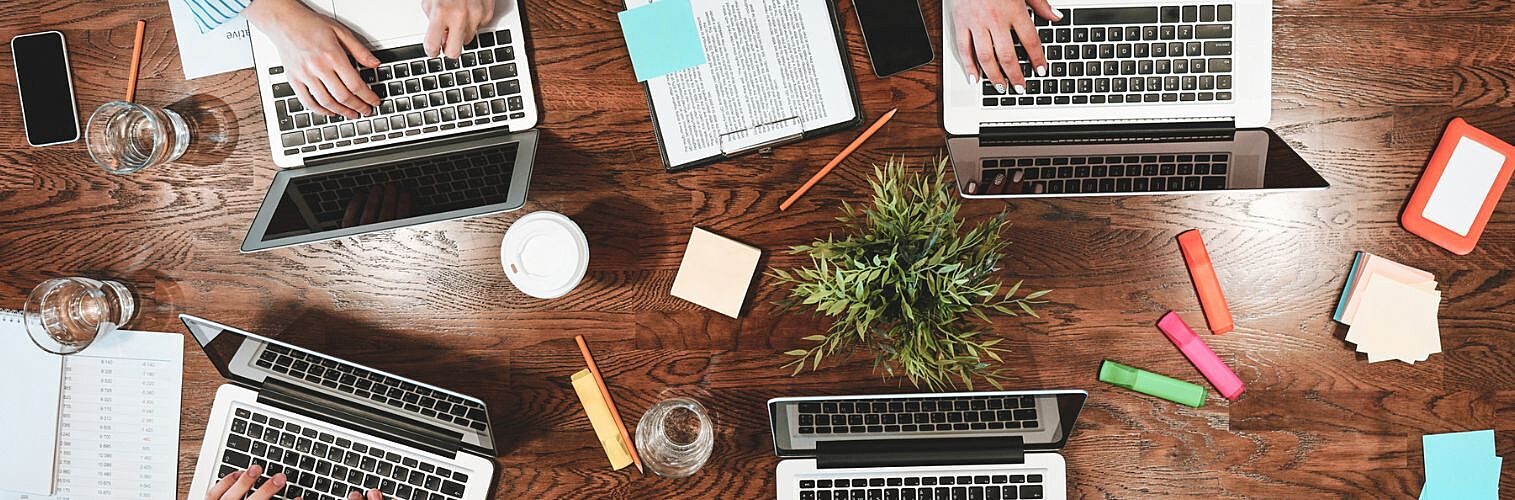 Group of business people working on an office desk.