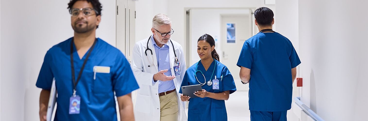 Doctors walking together in a hospital hallway.