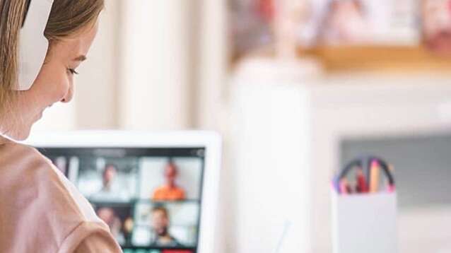 A woman wearing headphones in a virtual meeting