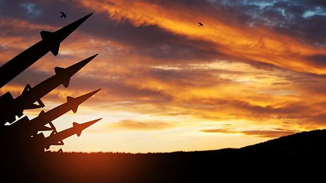 Missiles aimed at the sky at sunset.