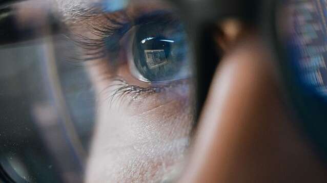 Close-up portrait of a software engineer working on a computer.