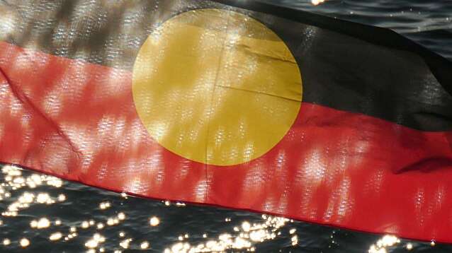 The Australian Aboriginal flag on a flagpole in Sydney.