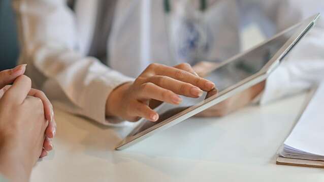 Shot of a doctor showing a patient some information on a digital tablet.