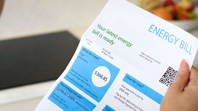 Close-up of woman opening an energy bill.
