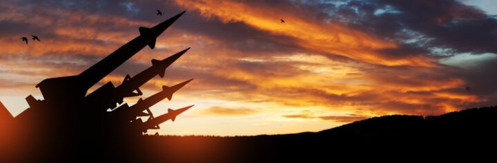 Missiles aimed at the sky at sunset.
