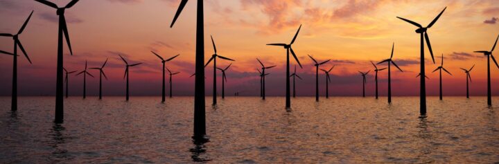 Offshore wind turbines at sunset.