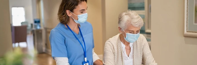 A patient and a nurse in surgical face masks