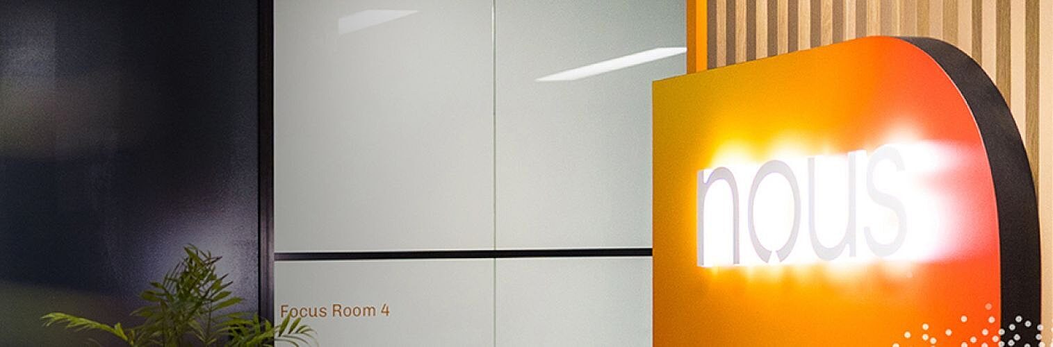 Nous Group office with illuminated Nous signage