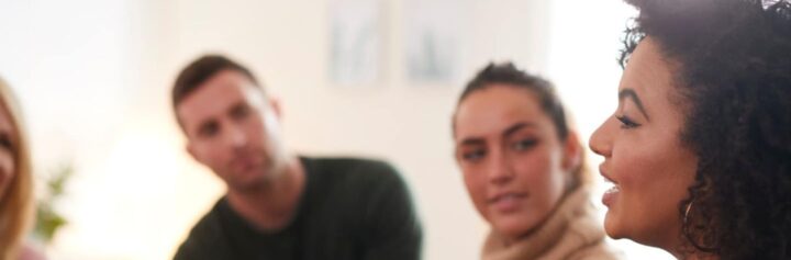 Woman talking to a small group of people