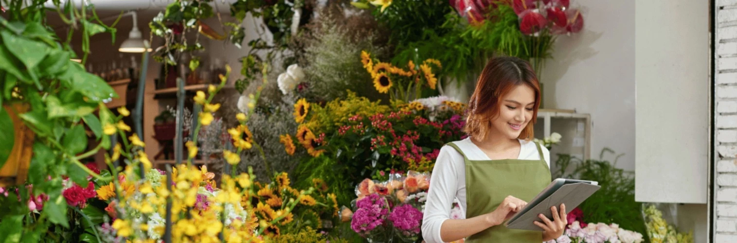 Florist working in shop on tablet