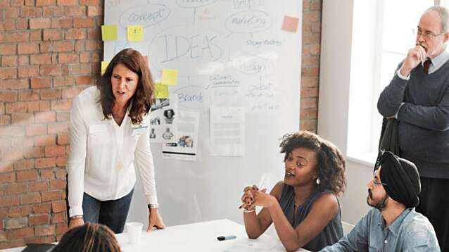 Group of people standing and sitting in a meeting room
