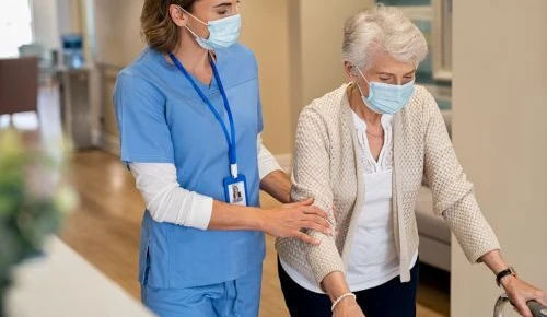 A patient and a nurse in surgical face masks
