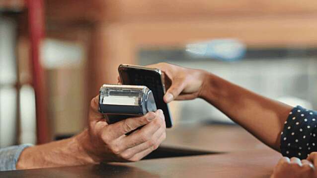 Woman making a payment on her phone