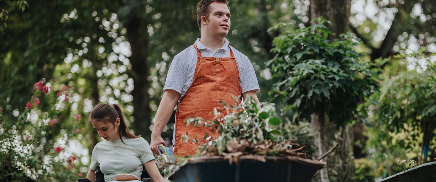 Two young people gardening in park setting
